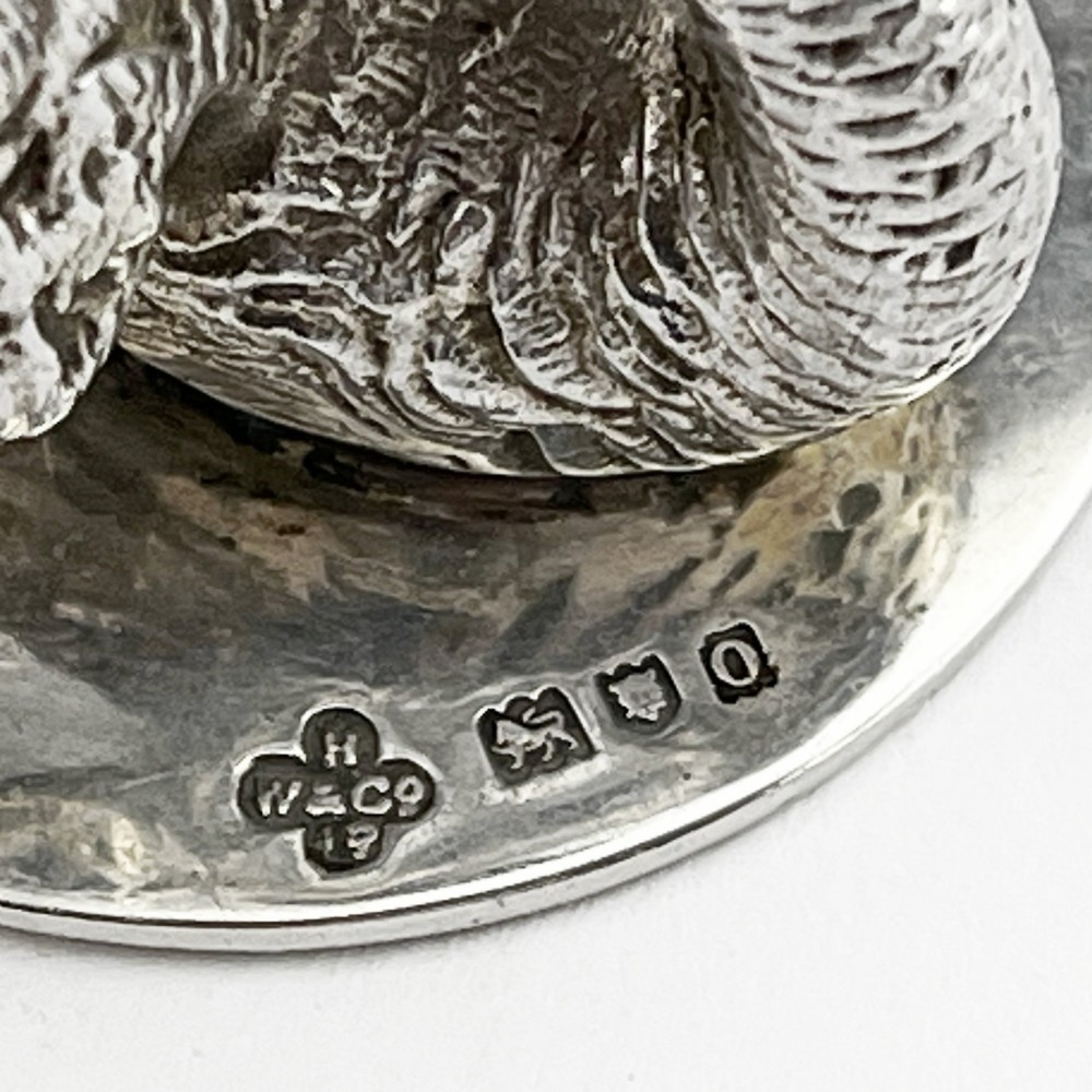 A pair of Edwardian sterling silver menu holders shaped as detailed swans resting on circular bases with central card slots. View VI