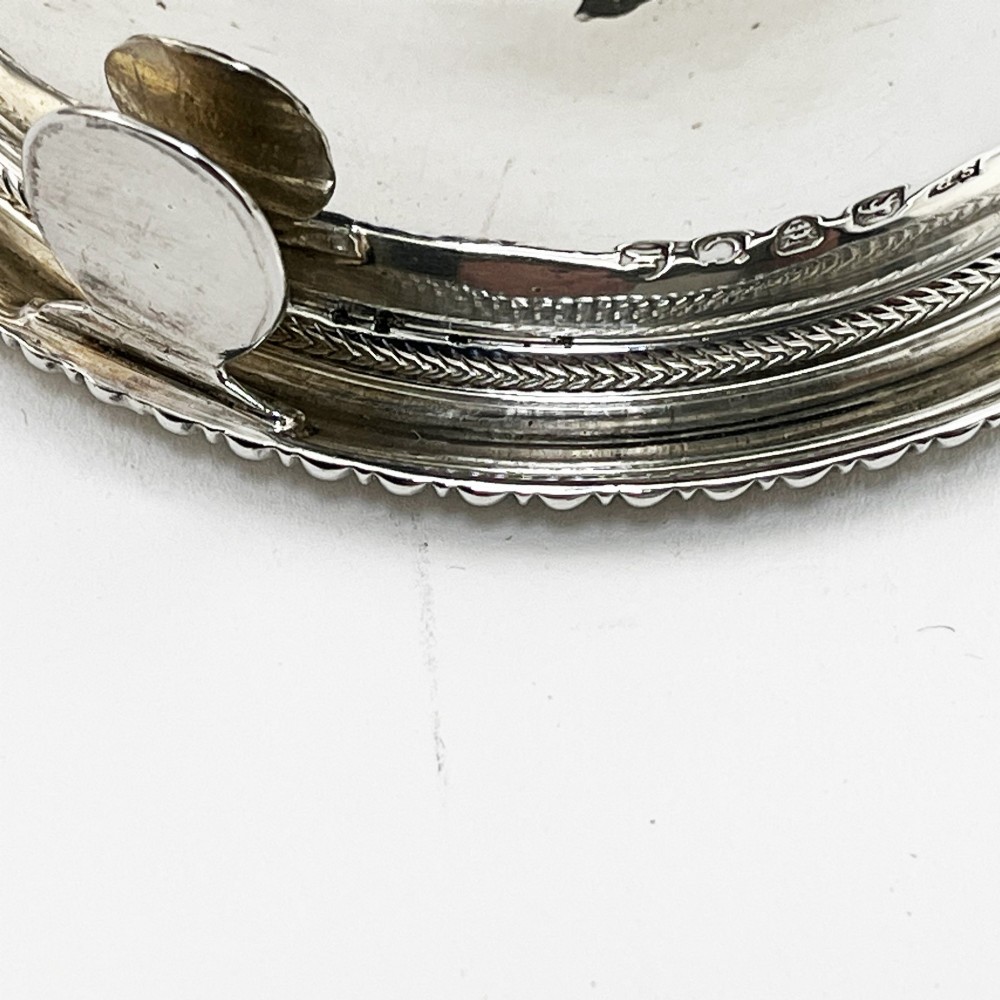 A Georgian sterling silver wine funnel resting on a beaded circular drip tray with visible hallmarks. View II