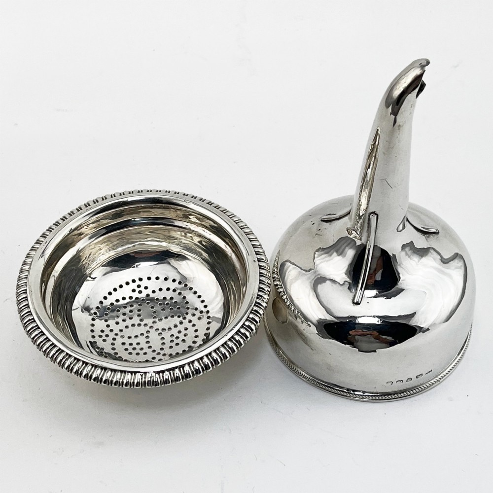A Georgian sterling silver wine funnel resting on a beaded circular drip tray with visible hallmarks. View IV