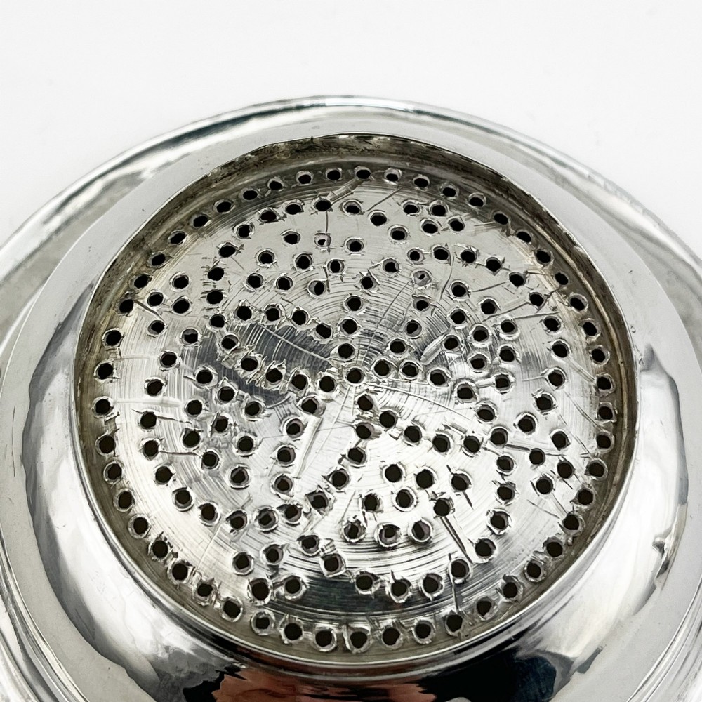 A Georgian sterling silver wine funnel resting on a beaded circular drip tray with visible hallmarks. View VI