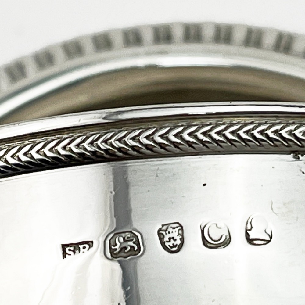 A Georgian sterling silver wine funnel resting on a beaded circular drip tray with visible hallmarks. View VII