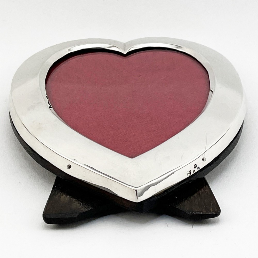 A heart-shaped sterling silver photo frame with a polished border, burgundy velvet backdrop, and an easel support leg. View II