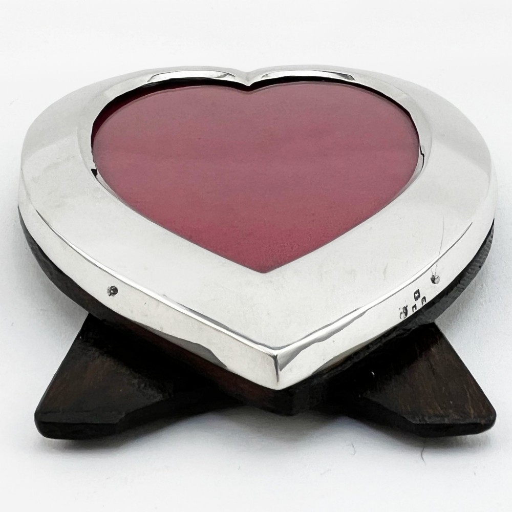 A heart-shaped sterling silver photo frame with a polished border, burgundy velvet backdrop, and an easel support leg. View IV