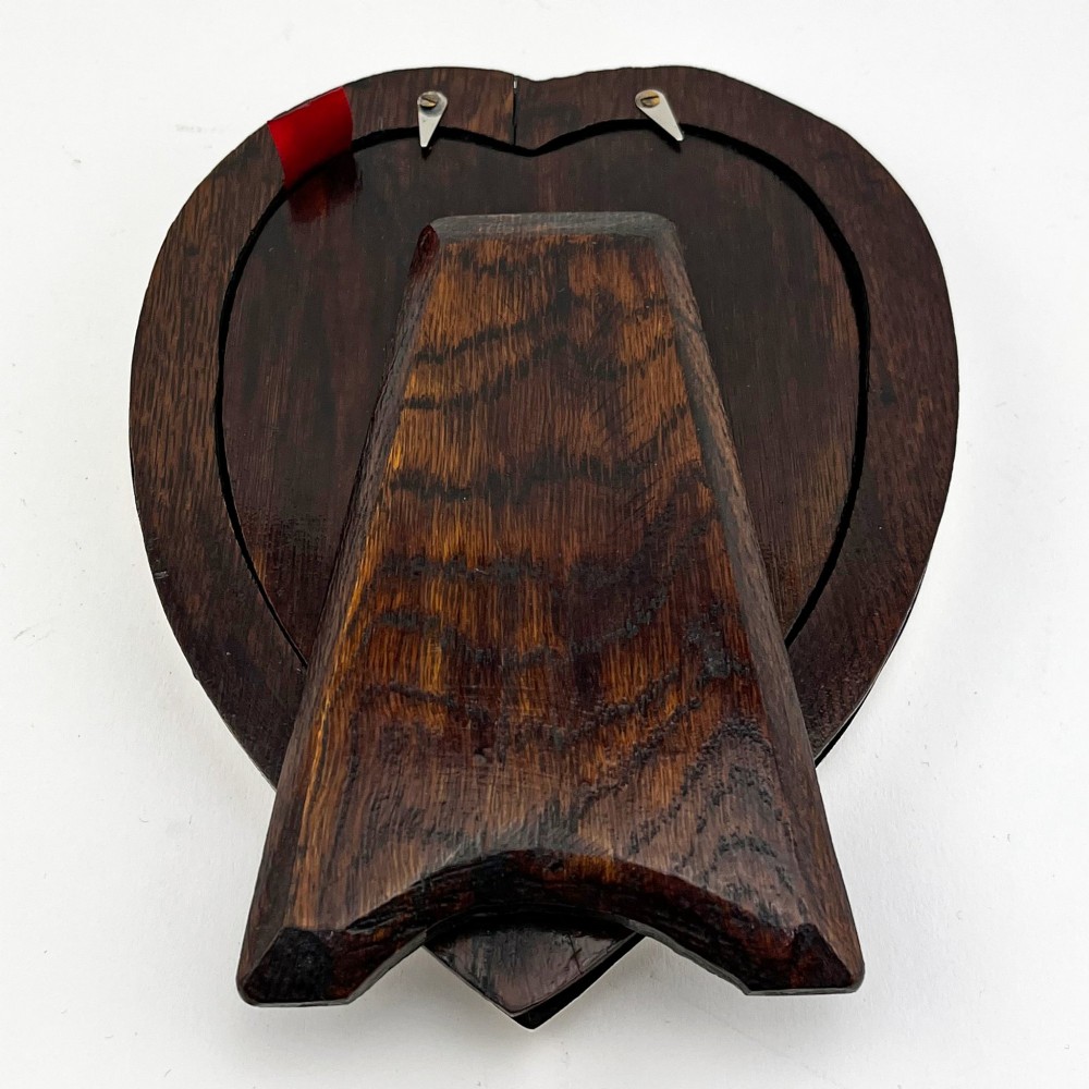 A heart-shaped sterling silver photo frame with a polished border, burgundy velvet backdrop, and an easel support leg. View VI