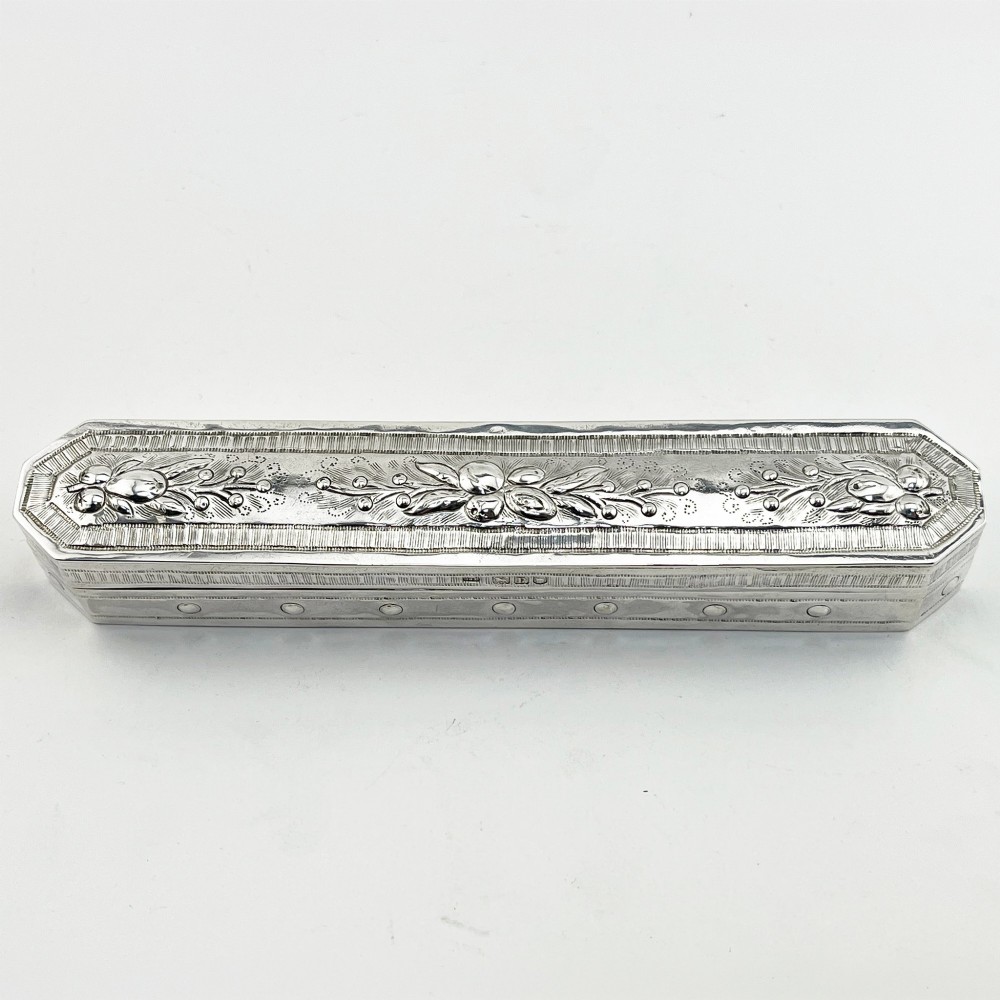 An elongated Edwardian sterling silver trinket box featuring embossed leaf motifs and visible hallmarks along the side. View II