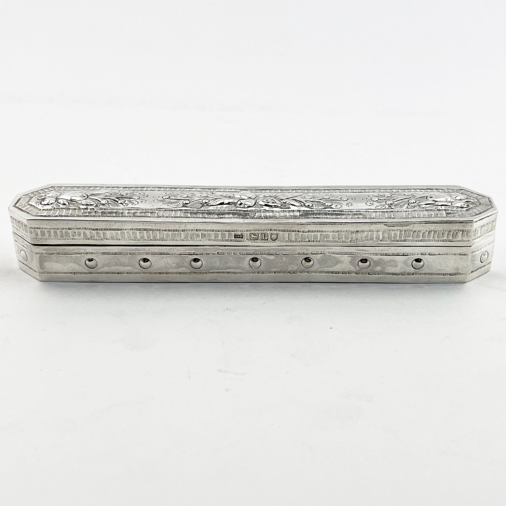 An elongated Edwardian sterling silver trinket box featuring embossed leaf motifs and visible hallmarks along the side. View III