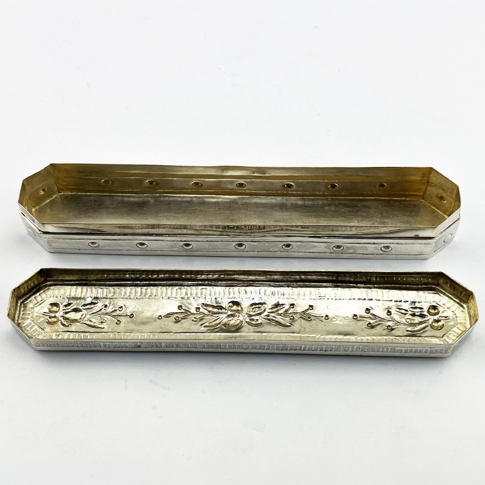 An elongated Edwardian sterling silver trinket box featuring embossed leaf motifs and visible hallmarks along the side. View IV
