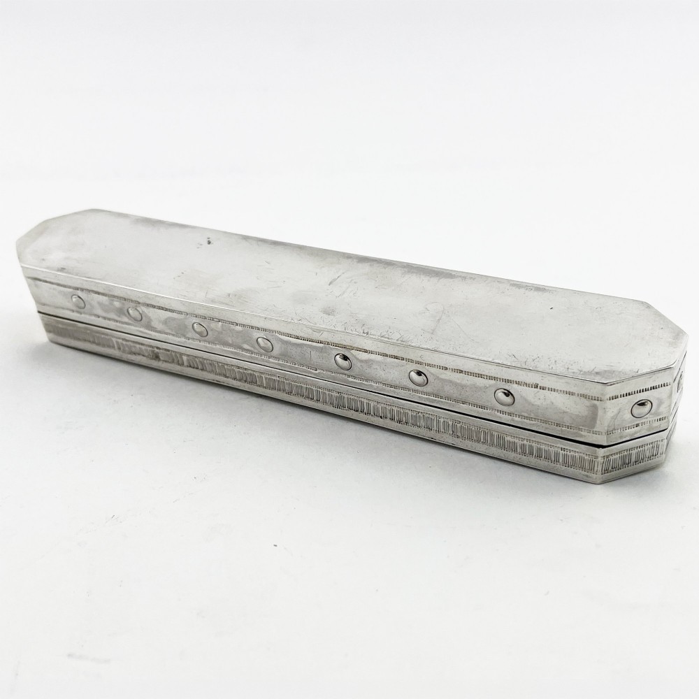 An elongated Edwardian sterling silver trinket box featuring embossed leaf motifs and visible hallmarks along the side. View VI