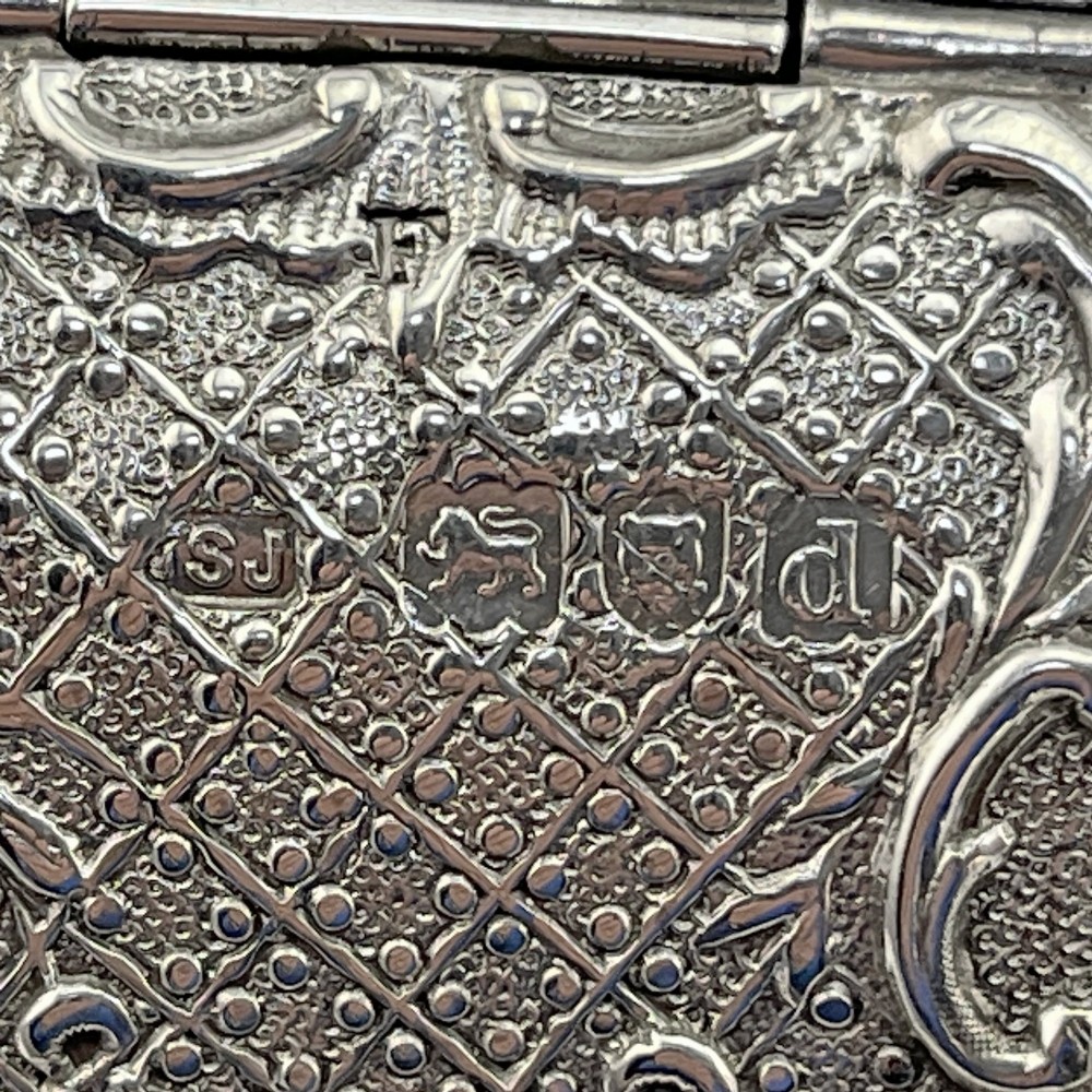 A Victorian sterling silver playing card case designed in the form of a sedan chair with embossed floral and scroll motifs. View VI