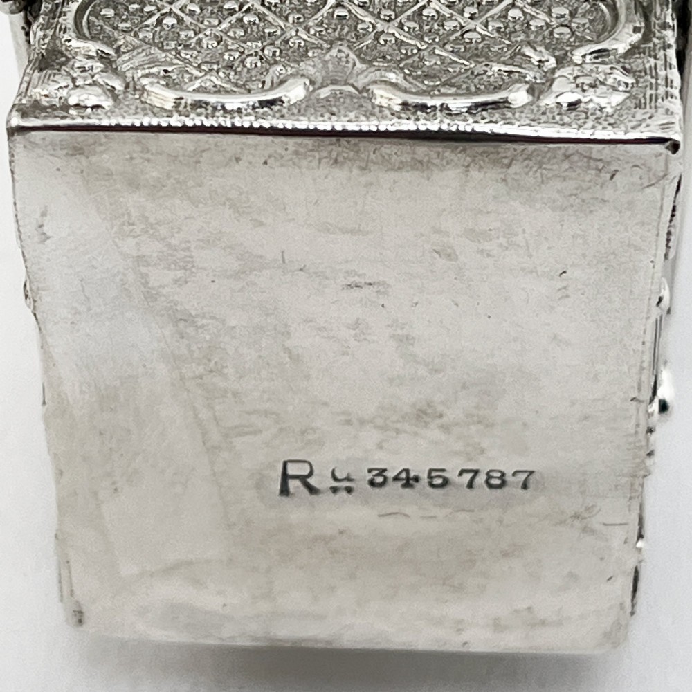 A Victorian sterling silver playing card case designed in the form of a sedan chair with embossed floral and scroll motifs. View VII