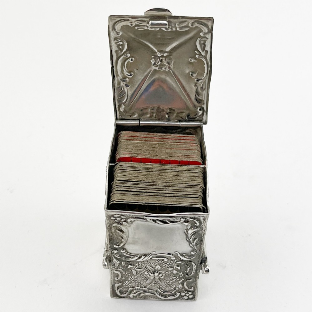 A Victorian sterling silver playing card case designed in the form of a sedan chair with embossed floral and scroll motifs. View VIII