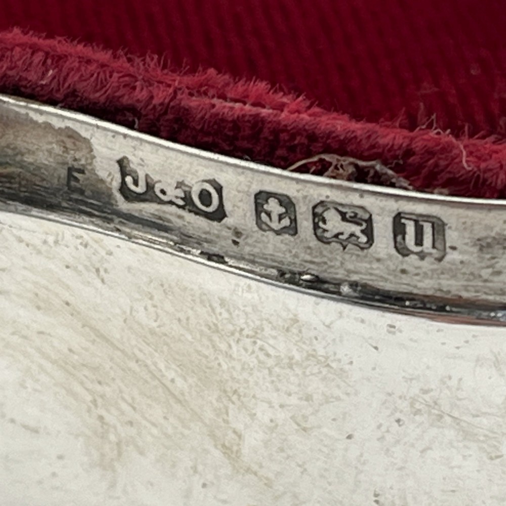 A polished sterling silver trinket box featuring a contoured lid and four shell-motif feet. View VI
