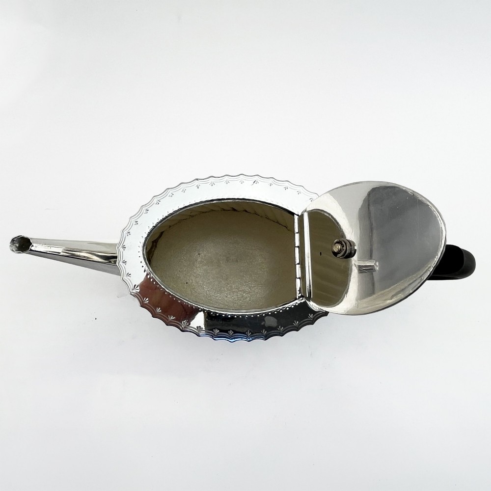 A four-piece Victorian silver-plated tea and coffee set featuring diagonal fluted body detailing and ebonised handles. View III