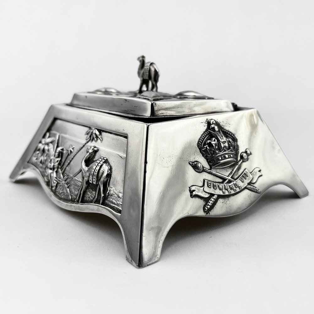 A square sterling silver trinket casket featuring a camel finial on the lid and detailed desert relief panels along the sides. View IV