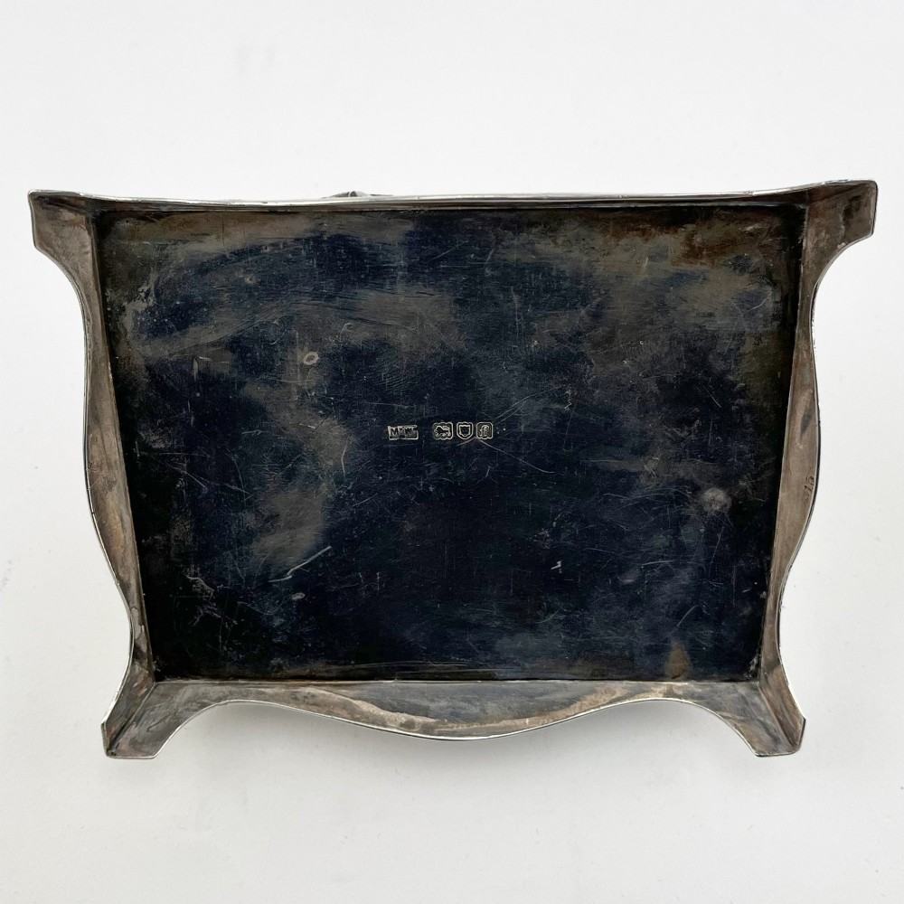 A square sterling silver trinket casket featuring a camel finial on the lid and detailed desert relief panels along the sides. View VIII