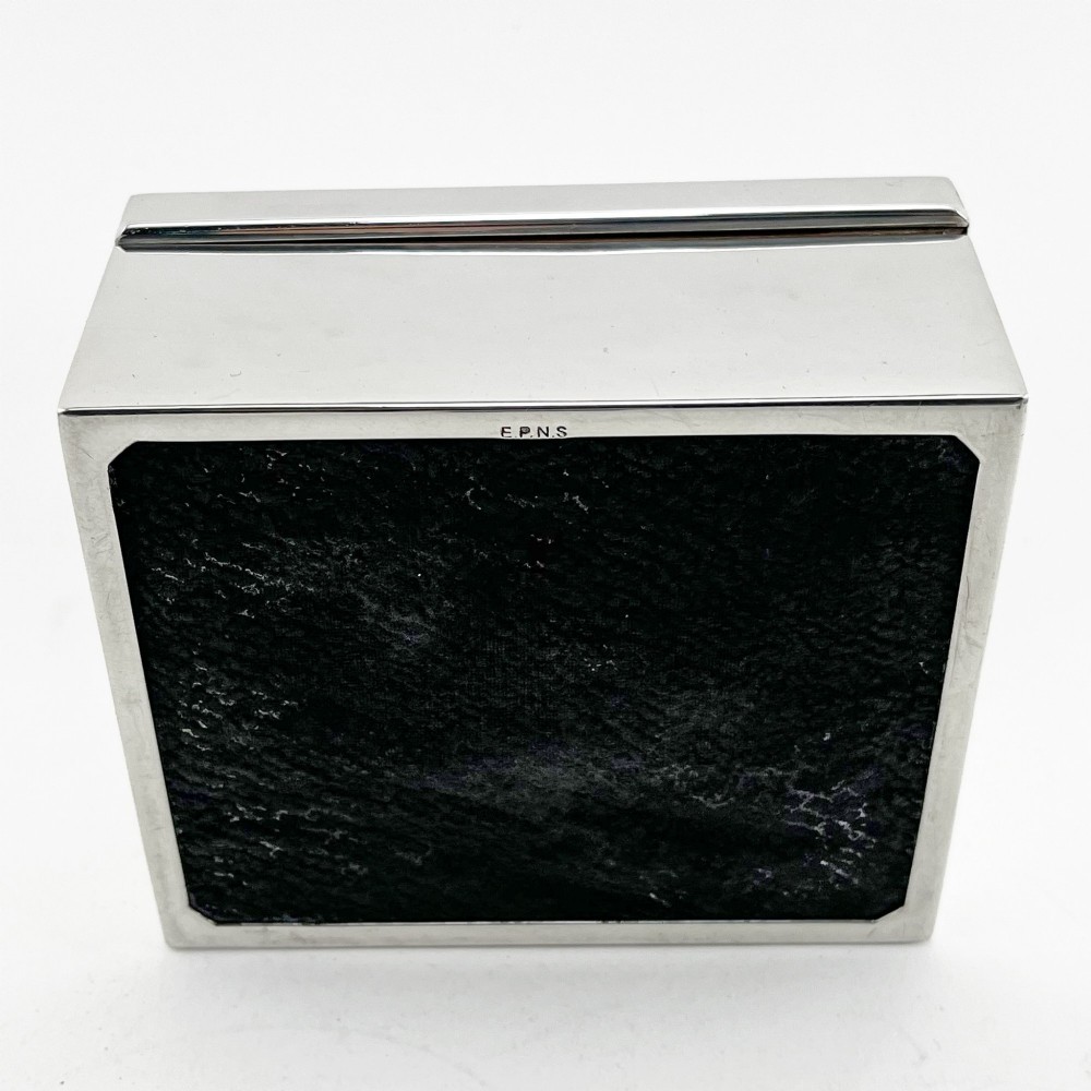 A rectangular silver-plated box featuring a polished finish and a sculpted figure of a standing greyhound attached to the lid. View VI