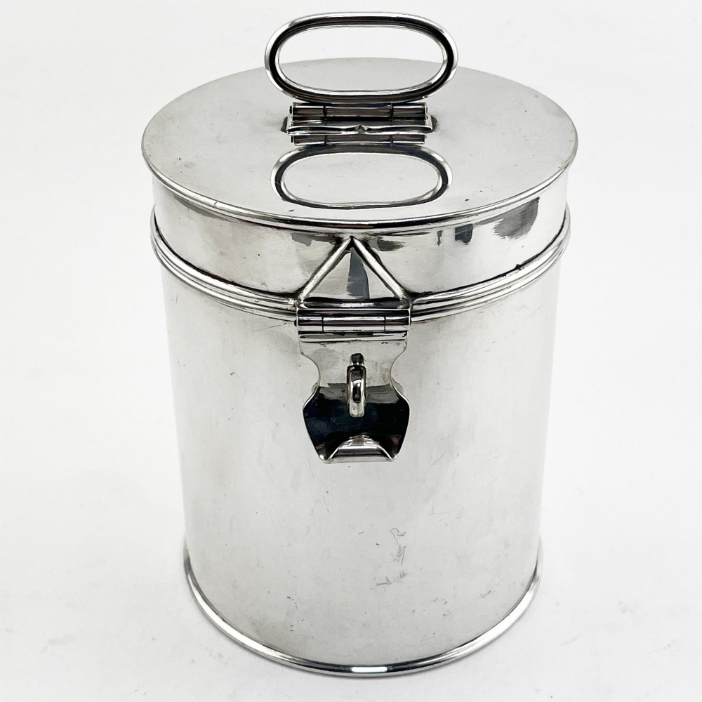 A cylindrical late Victorian silver-plated campaign canister featuring a top folding loop handle and front latch mechanism.