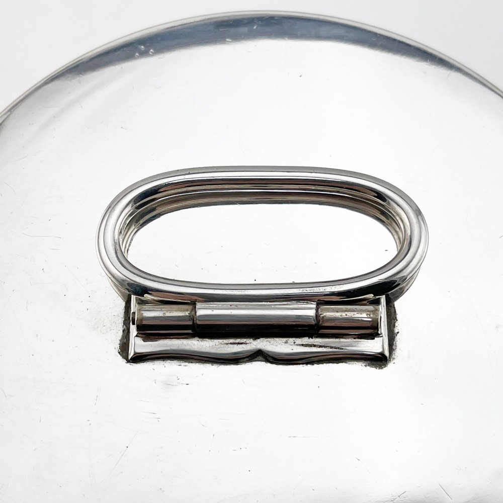 A cylindrical late Victorian silver-plated campaign canister featuring a top folding loop handle and front latch mechanism. View II