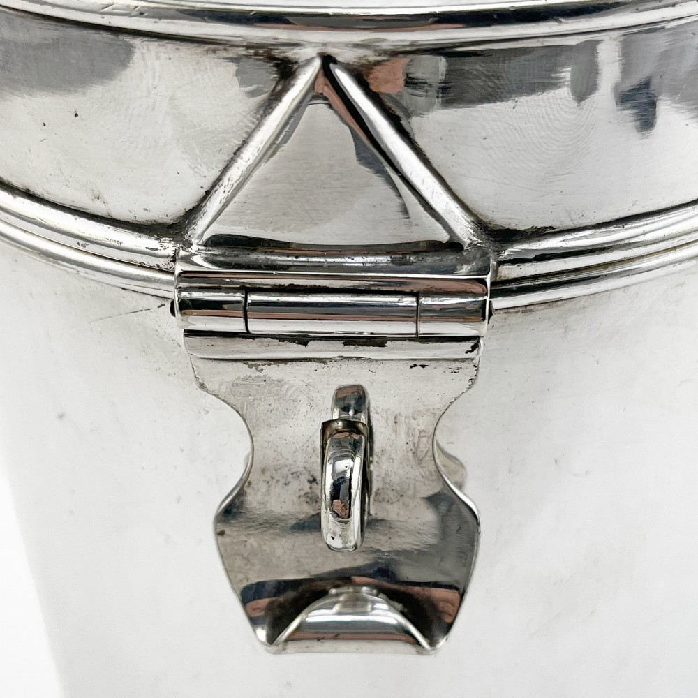 A cylindrical late Victorian silver-plated campaign canister featuring a top folding loop handle and front latch mechanism. View III