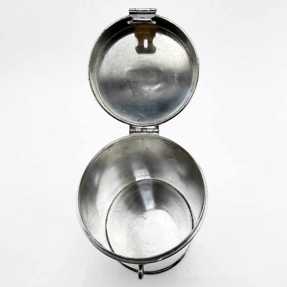 A cylindrical late Victorian silver-plated campaign canister featuring a top folding loop handle and front latch mechanism. View IV