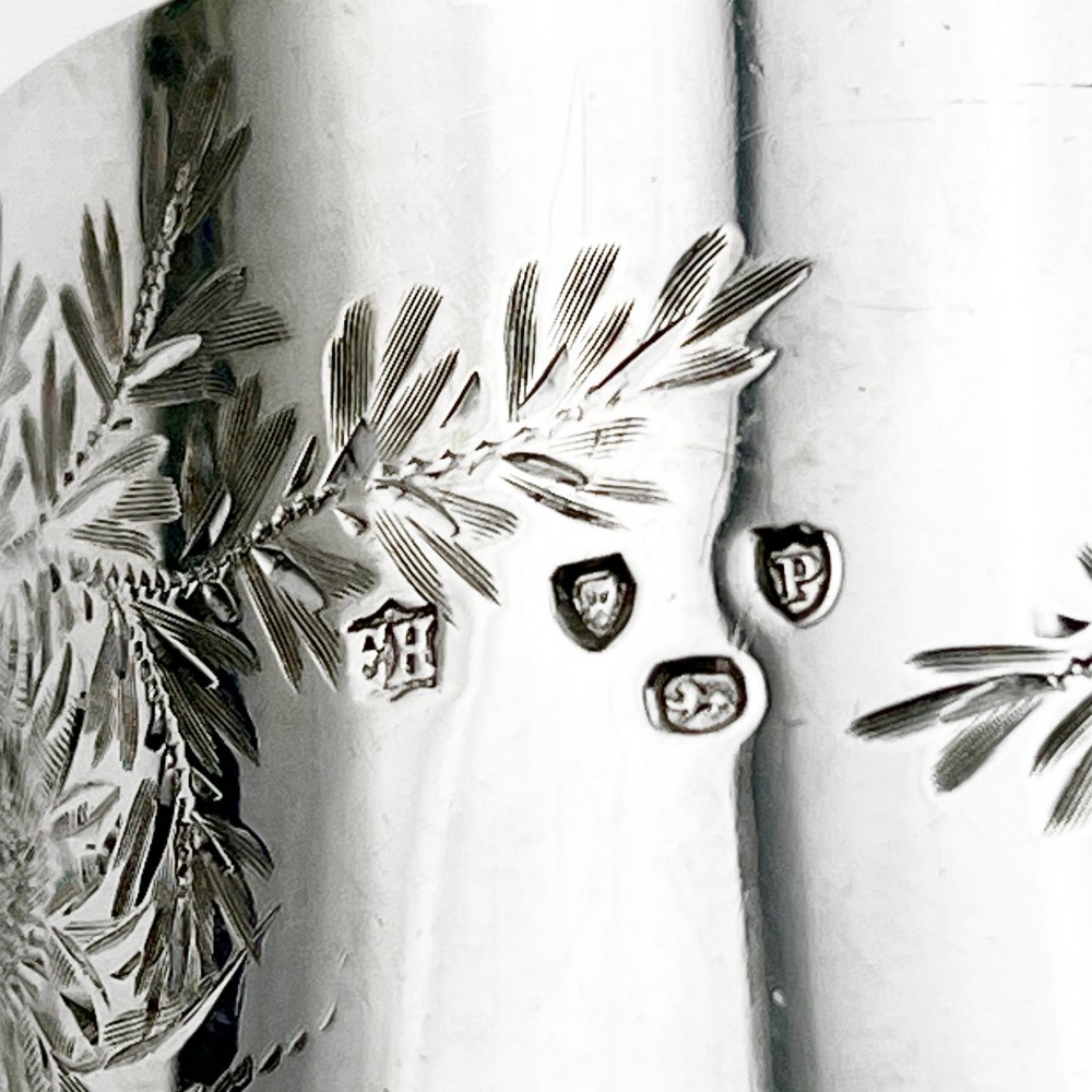 A pair of engraved Victorian sterling silver napkin rings numbered 1 and 2 inside a fitted velvet display case. View IV