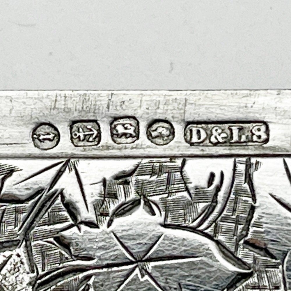 An engraved Victorian sterling silver visiting card case with ivy foliage patterning, seated inside a purple velvet-lined presentation box. View VII