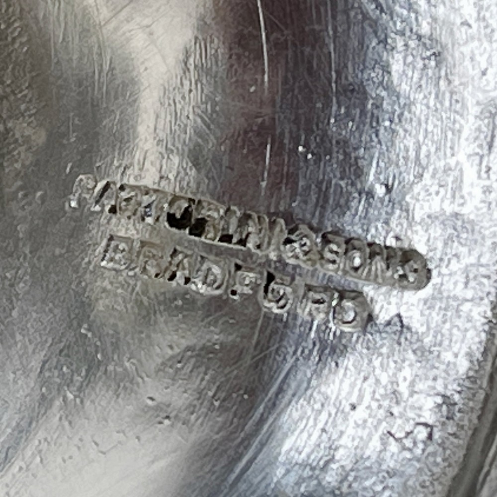 A silver-plated Victorian trophy cup featuring chased scrollwork, twin high-arched loop handles, and a stepped circular pedestal base. View VIII