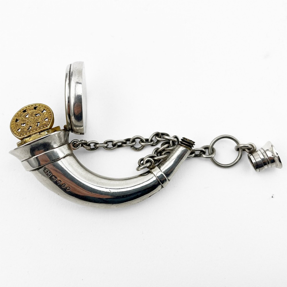 A Victorian sterling silver horn-shaped scent bottle with attached chain links and stamped British hallmarks. View II