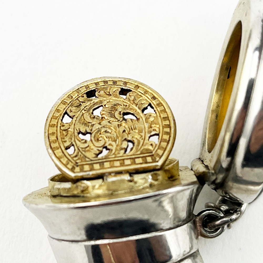 A Victorian sterling silver horn-shaped scent bottle with attached chain links and stamped British hallmarks. View III