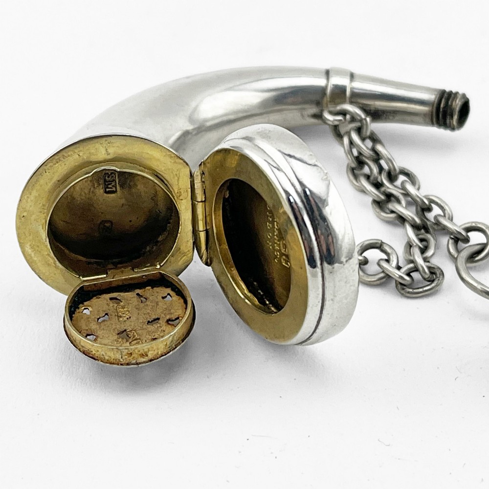 A Victorian sterling silver horn-shaped scent bottle with attached chain links and stamped British hallmarks. View IV