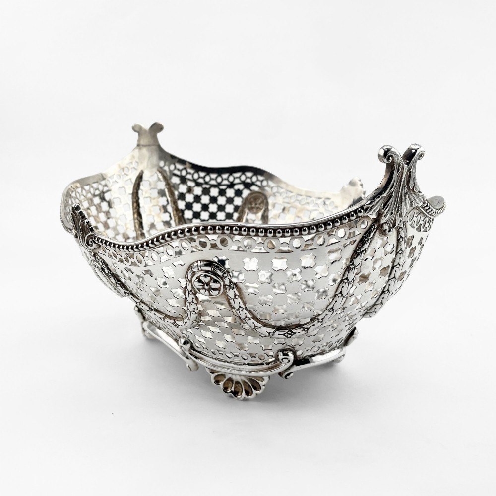 A boat-shaped sterling silver pierced dish with decorative swags, bead borders, and shell-motif feet. View III