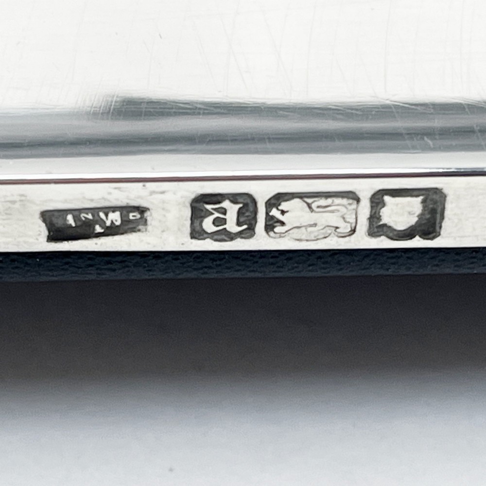 A large rectangular sterling silver photo frame with a polished finish and a carved ribbon bow crest at the top. View IV