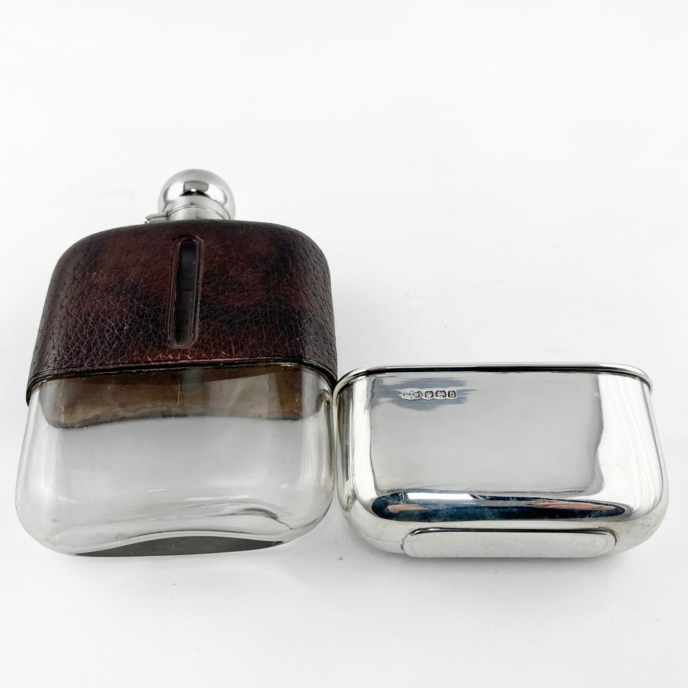 A sterling silver and textured dark brown leather hip flask with a bayonet cap, sight level window, and detachable silver base cup. View IV