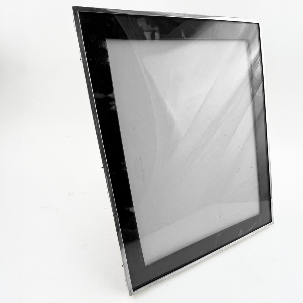 A rectangular picture frame with a mottled brown tortoiseshell border encased within a slim sterling silver outer rim. View III