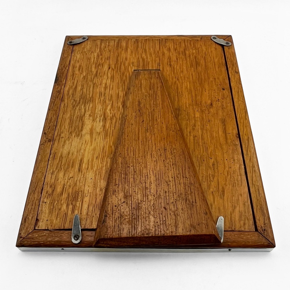 A rectangular picture frame with a mottled brown tortoiseshell border encased within a slim sterling silver outer rim. View VII