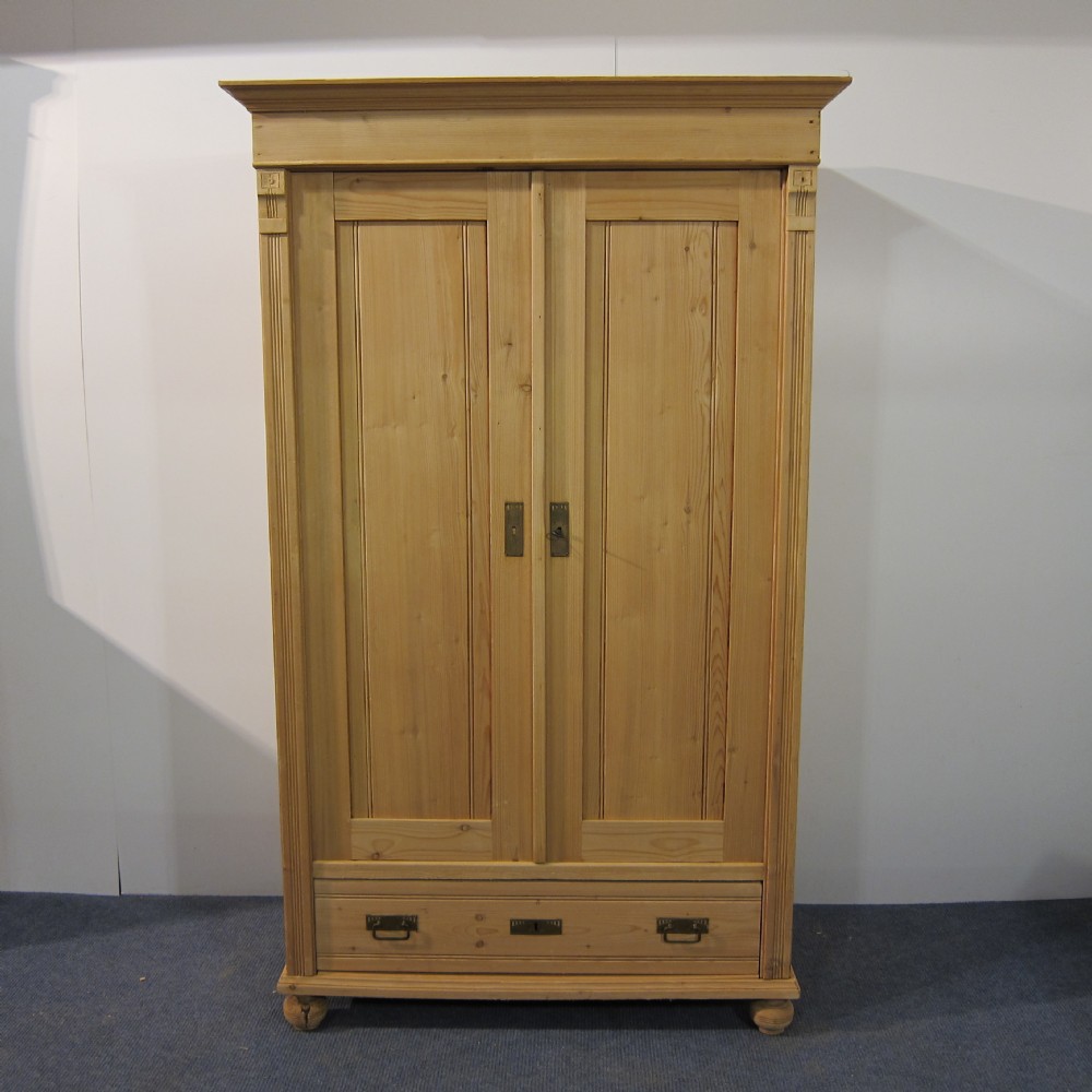 Small antique pine wardrobe with a bottom drawer