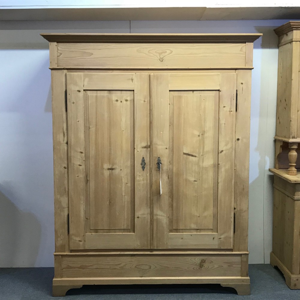 A DEEP DOUBLE ANTIQUE PINE WARDROBE (DISMANTLES)