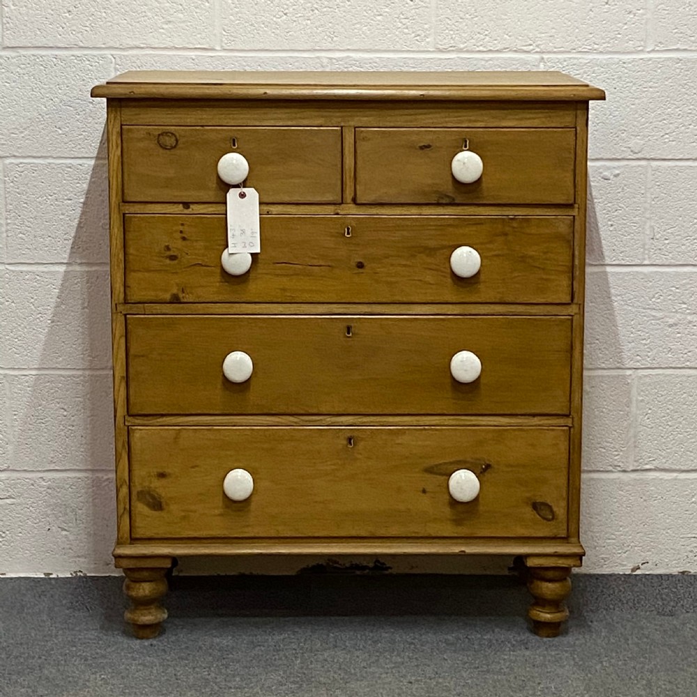 A WAXED ENGLISH VICTORIAN PINE CHEST OF DRAWERS