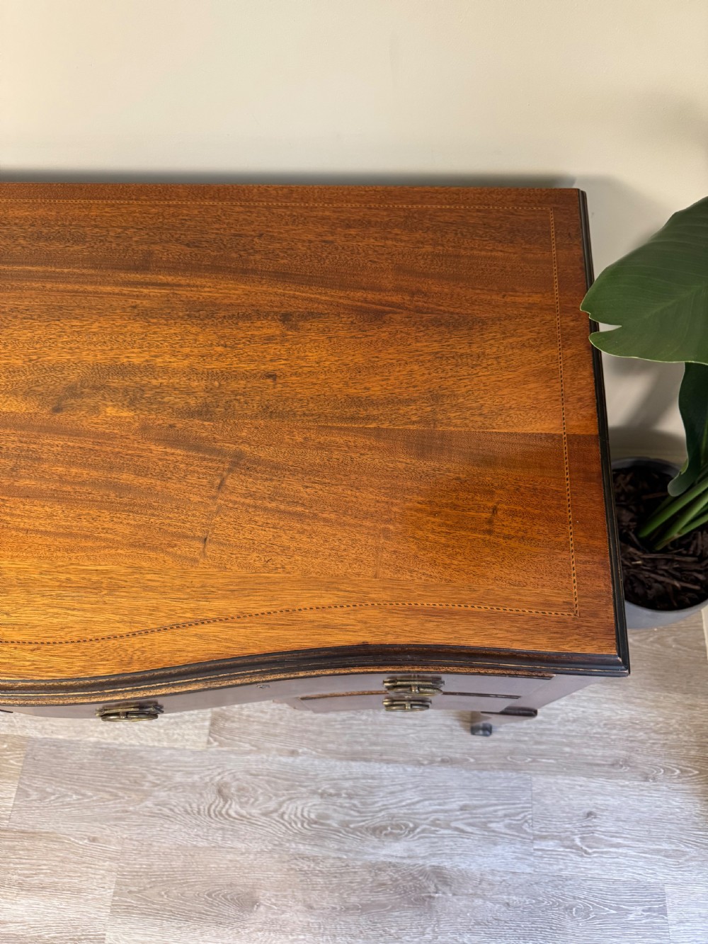 An Edwardian solid mahogany dressing table with brass drop handles, multiple drawers, a kneehole apron, and tapered legs. View VII