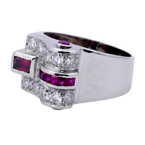 fig 1. An Art Deco platinum ring featuring a geometric buckle motif set with brilliant-cut diamonds and channel-set red rubies.