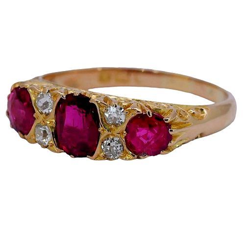 fig 1. An antique yellow gold ring set with three red rubies and four small old cut diamonds in a carved head setting.