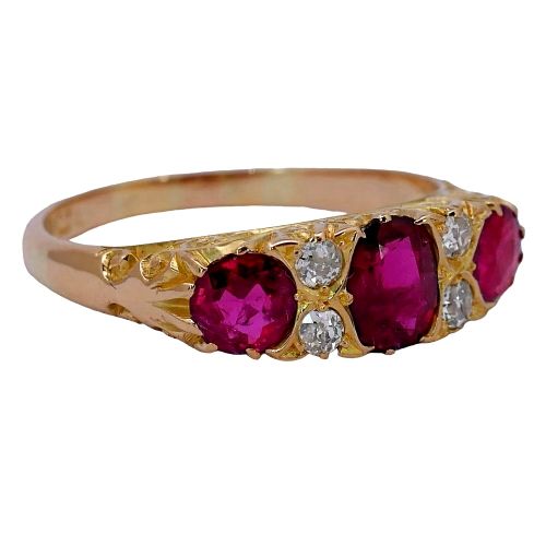 fig 2. An antique yellow gold ring set with three red rubies and four small old cut diamonds in a carved head setting.