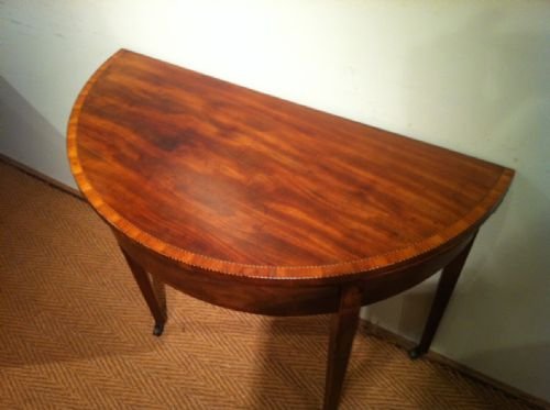 fig 1. A George 111 mahogany half round tea table c 1790