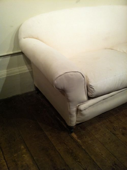 fig 1. A late Victorian 2 seater country house sofa c1900 with down and feather cushions on turned mahogany legs  
