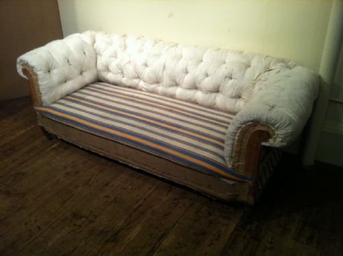 A Victorian Button Back Chesterfield Sofa C 1880 on  Turned Mahogany Legs Brass Cappings and Castors  


