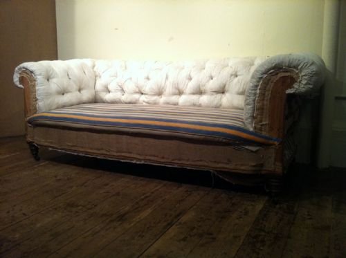 fig 1. A Victorian button back chesterfield sofa c 1880 on turned mahogany legs brass cappings and castors