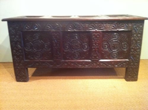 fig 1. A large and well carved early Charles 1 marriage coffer. the front carved with the initials AM and AW and dated in the centre 1624 . The top with 4 panels