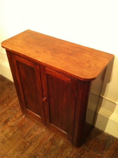 fig 1. A Victorian mahogany 2 door side cabinet c 1870 with bowed sides and a shelved interior .