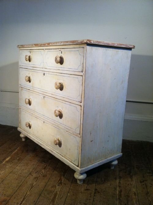 fig 1.  A Victorian painted pine chest of drawers c 1880 with the original white painted decoration and blue lines .