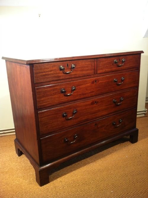 fig 1. A Chippendale period George 111 mahogany chest of drawers c 1770 with original brass swan neck handles on bracket feet.